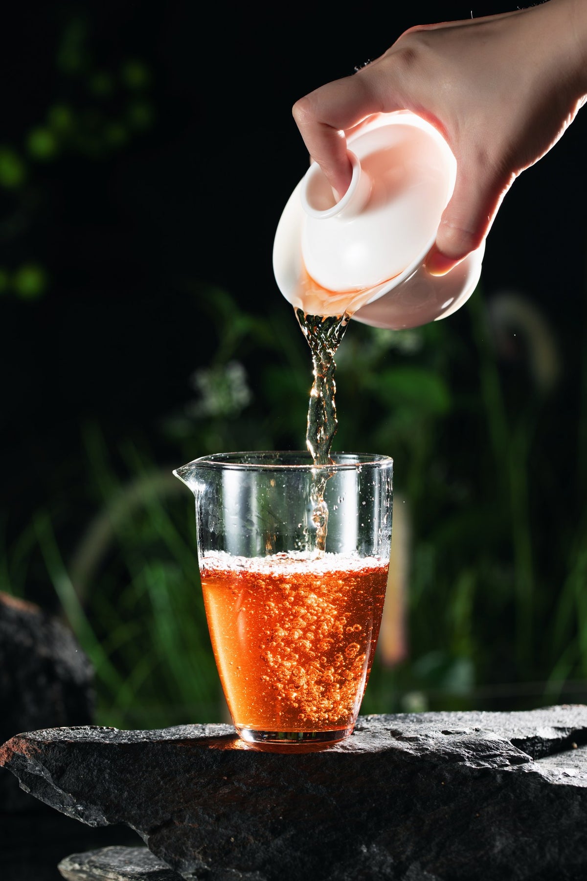 Pouring Red Robe from a gaiwan — amber liquor