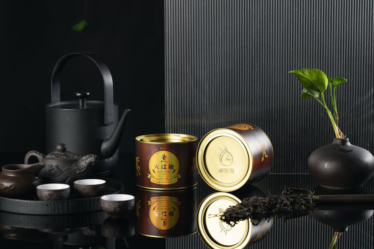 Red Robe tins with dark clay teaware on a tea table